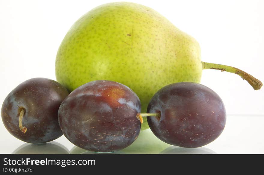 Three plum and pear on a white background. Was on a glass substrate.