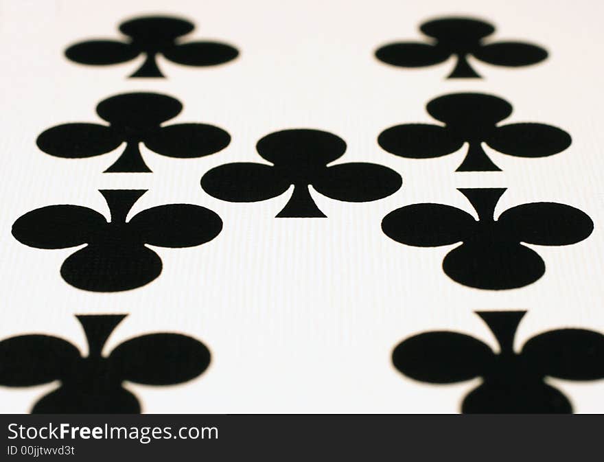 Abstract close up of nine of clubs with selective focus on center club. Abstract close up of nine of clubs with selective focus on center club.