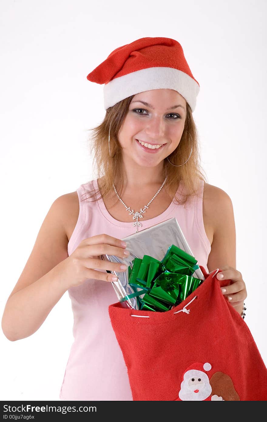 Girl wearing a santa hat and holding a gift box. Girl wearing a santa hat and holding a gift box