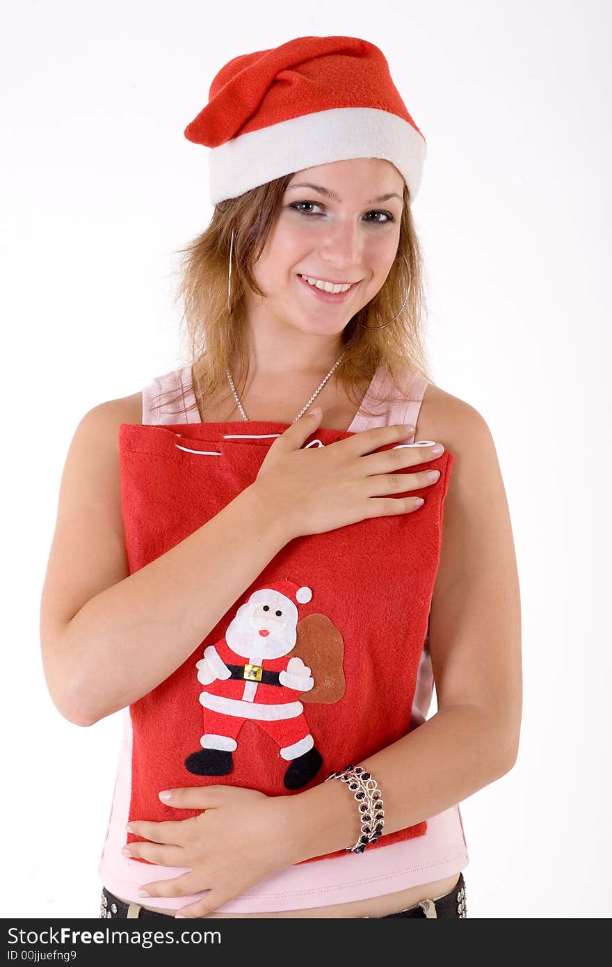 Girl wearing a santa hat and holding christmas bag. Girl wearing a santa hat and holding christmas bag