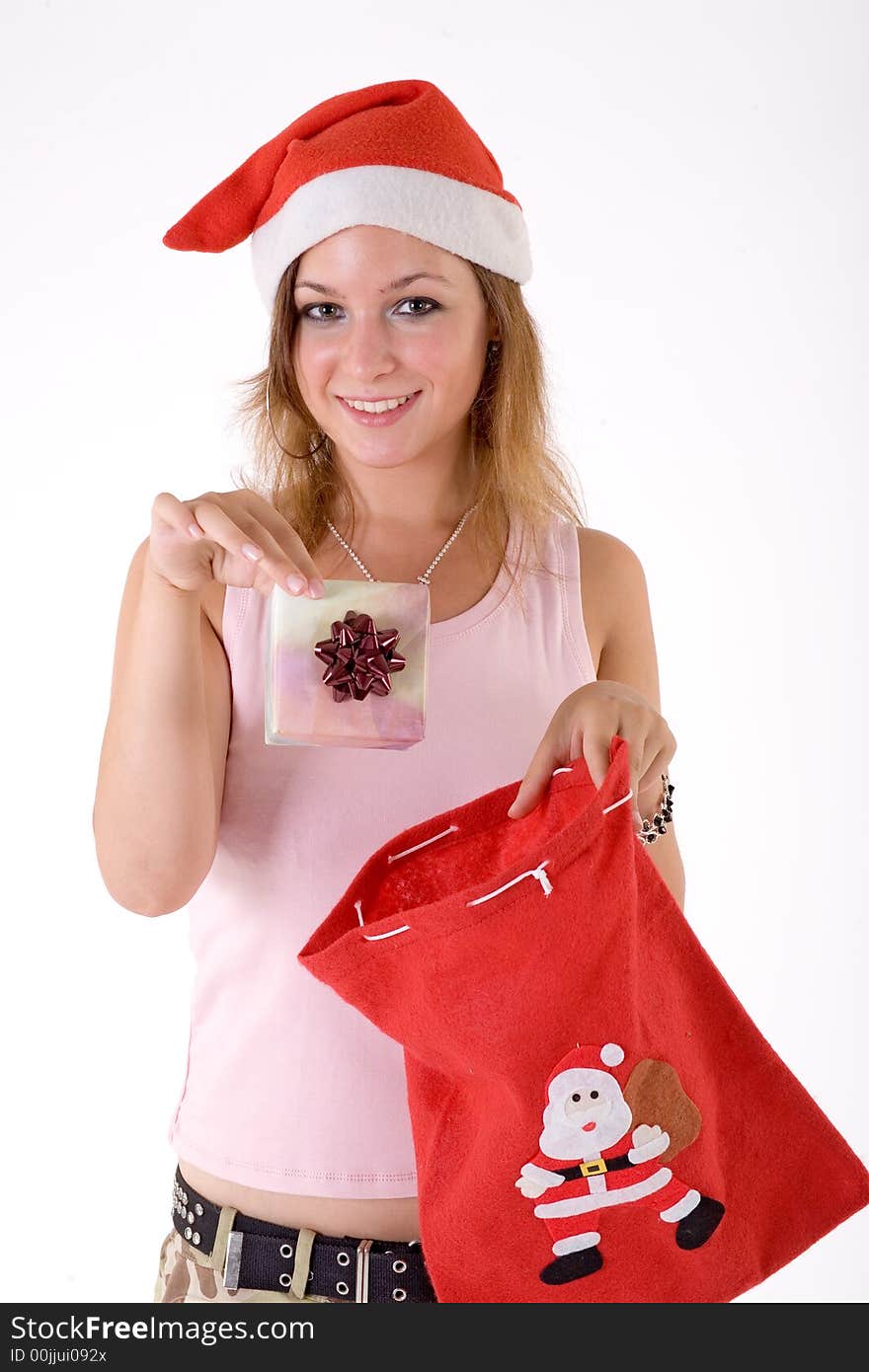 Girl wearing a santa hat and holding a gift box. Girl wearing a santa hat and holding a gift box