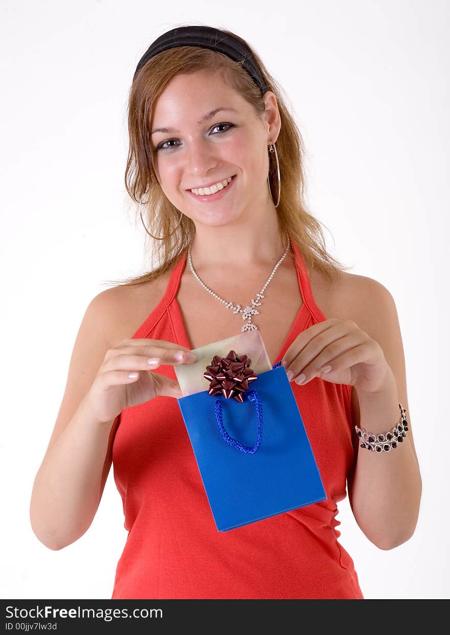 Girl wearing a santa hat and holding a gift box. Girl wearing a santa hat and holding a gift box