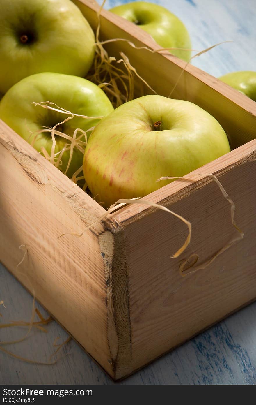 Green apples in the  wooden box