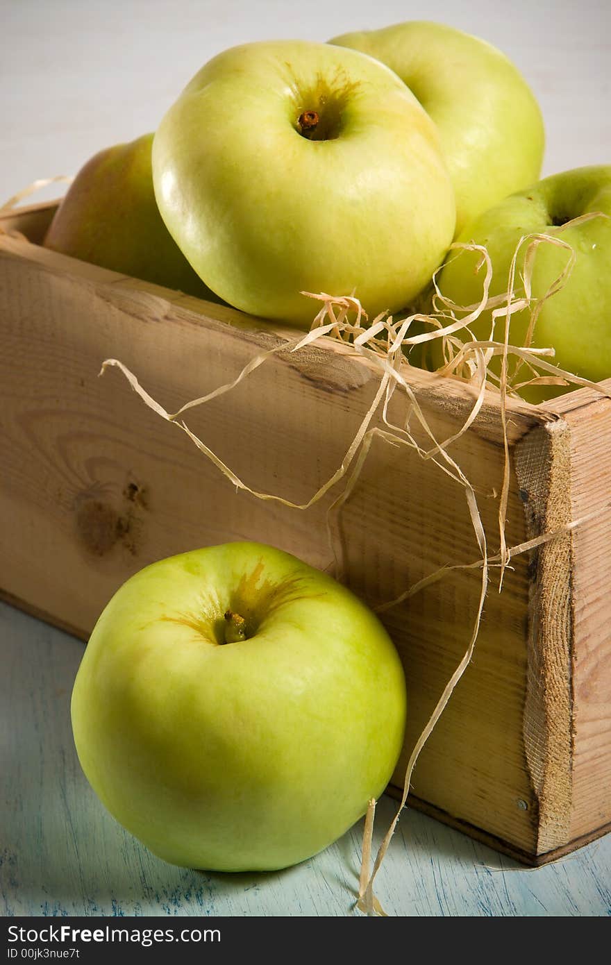 Green apples in the  wooden box. Green apples in the  wooden box