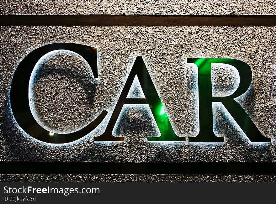 CAR word glow on textured wall - detail