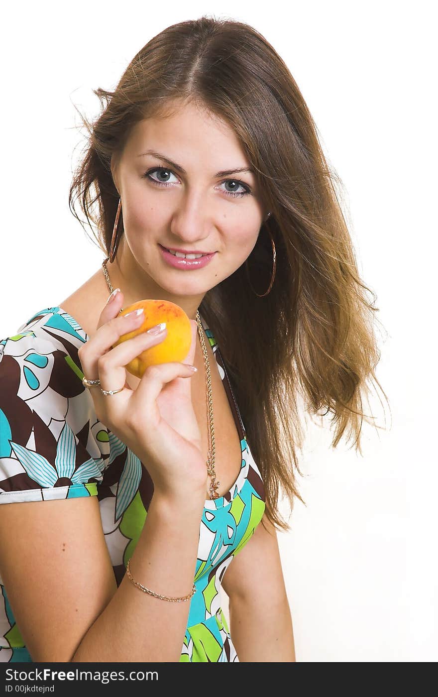 The young beautiful girl with a peach on a white background. The young beautiful girl with a peach on a white background