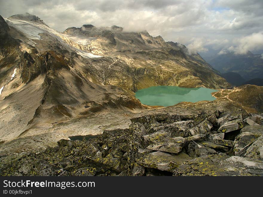 Blue lake in Austrian Alps among high mountains. Blue lake in Austrian Alps among high mountains.