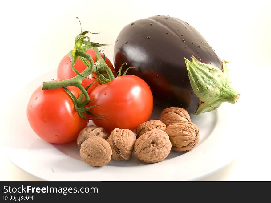 Fresh  eggplant,tomatoes,walnuts -isolated on white. Fresh  eggplant,tomatoes,walnuts -isolated on white.