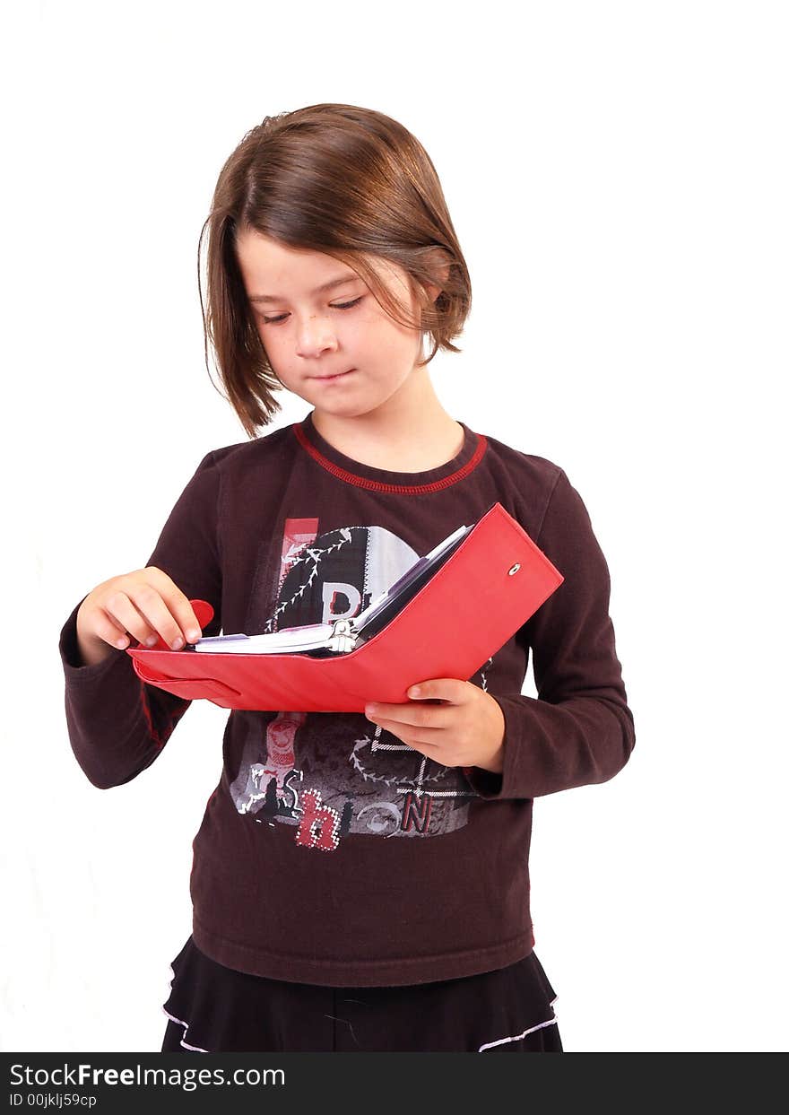 Brunette girl looking at a red book. Brunette girl looking at a red book