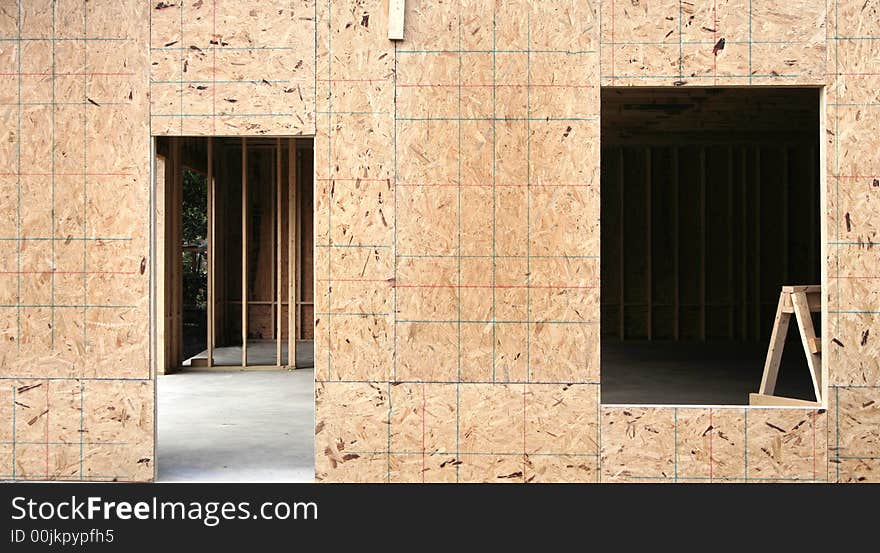 Plywood framing and cutouts for a home under construction. Plywood framing and cutouts for a home under construction.