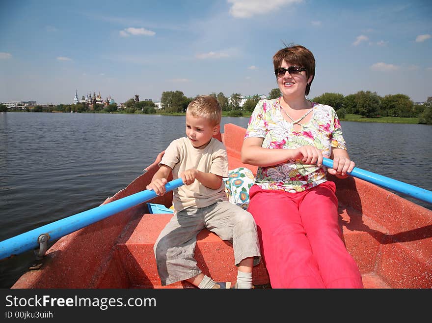 Woman and boy in the boat with the oars