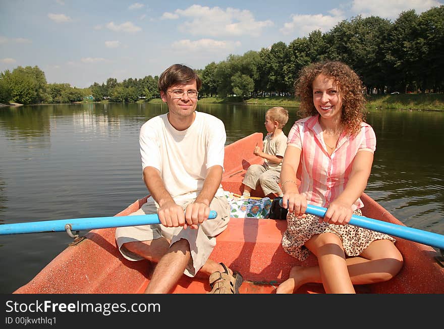 Father, mother and son in the boat