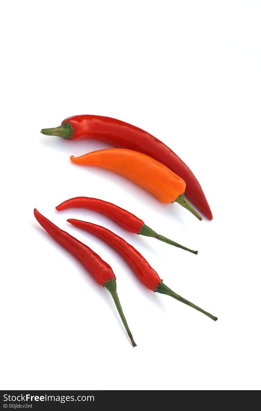 Five peppers isolated on white background. Five peppers isolated on white background.