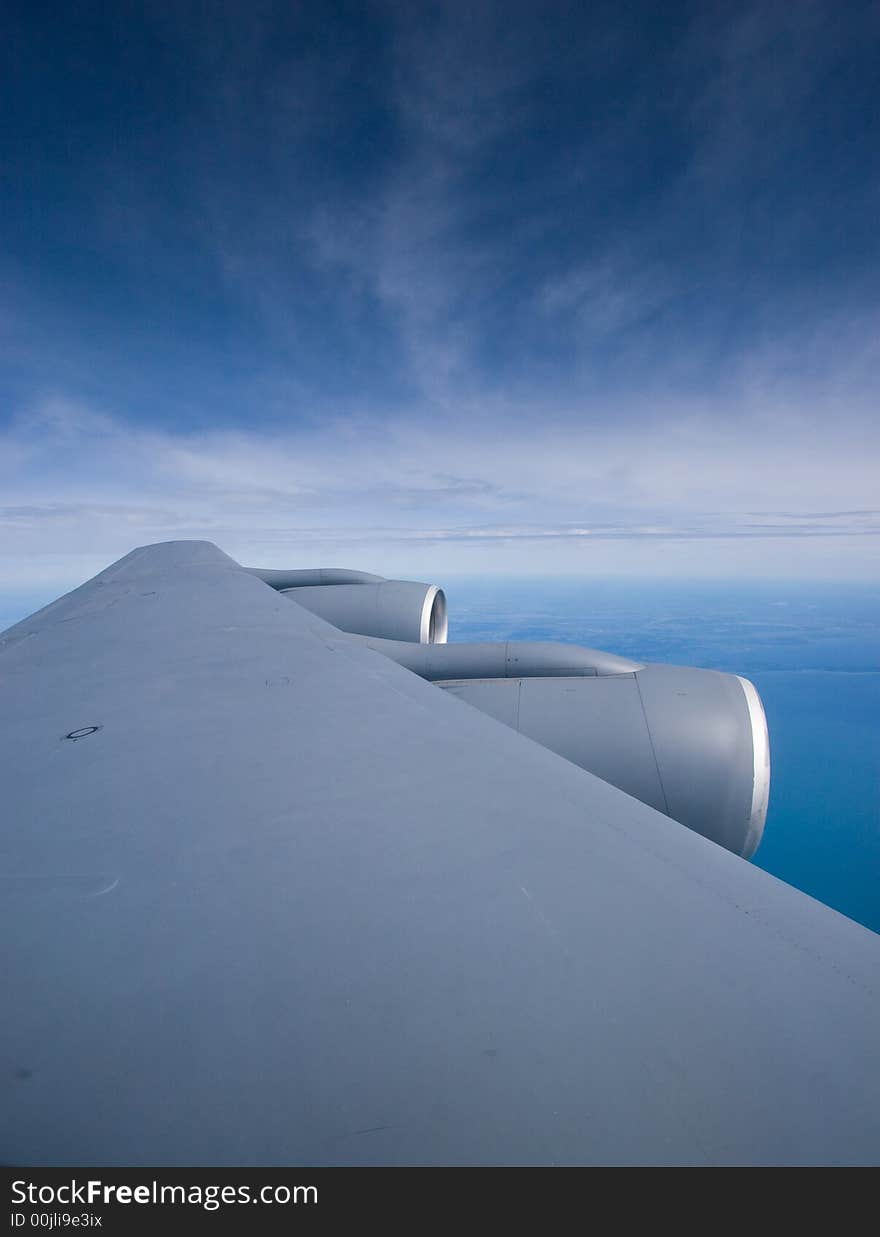 Sky and wing of a KC-135 military jet, in flight with a blue sky background. Sky and wing of a KC-135 military jet, in flight with a blue sky background