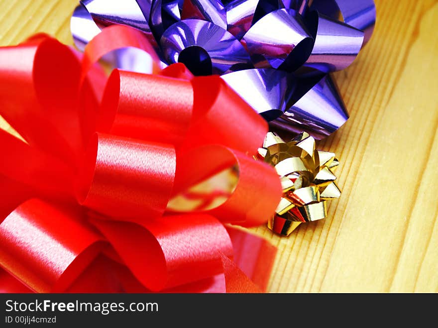 Three bows on wooden table