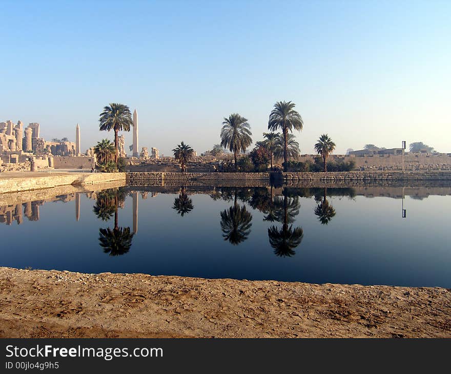 The reflection of palms and monuments, abeliscs in water