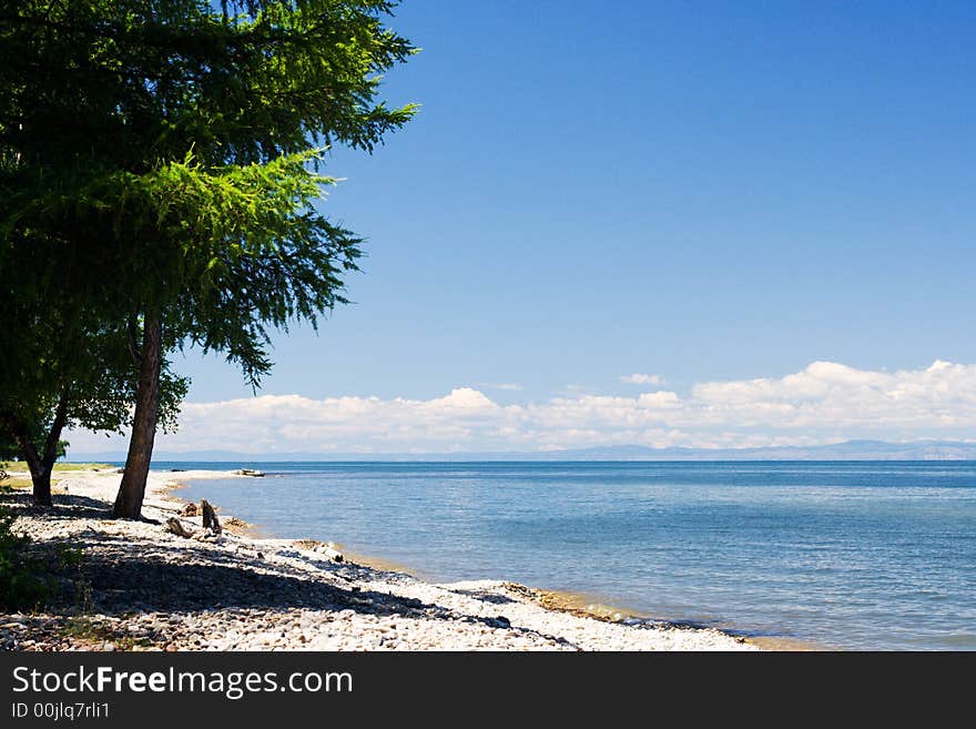 Baikal lakeside with mountains of Olhon island on skyline (lake Baikal - first-rate reservoir of unadulterated sweet water, it contains about 1/4 of all world's reserve)