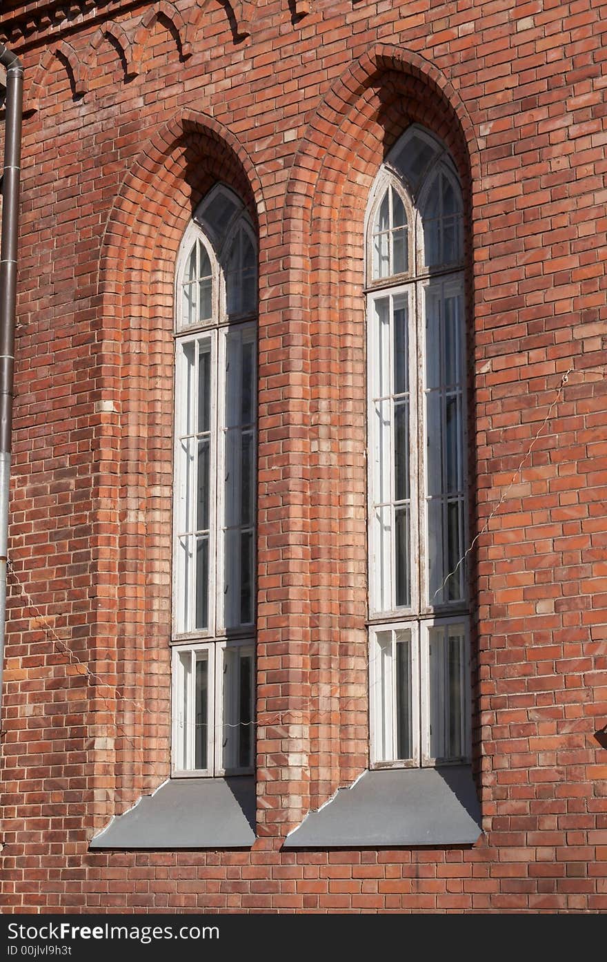Red brick wall of church with windows. Red brick wall of church with windows