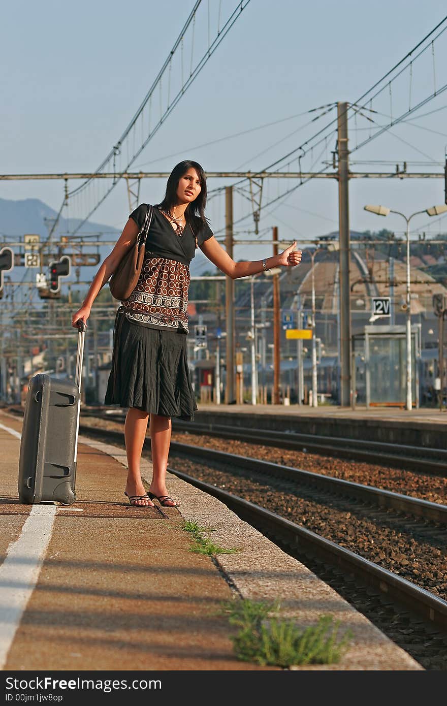 Woman leaving travels from there with her luggage. Woman leaving travels from there with her luggage