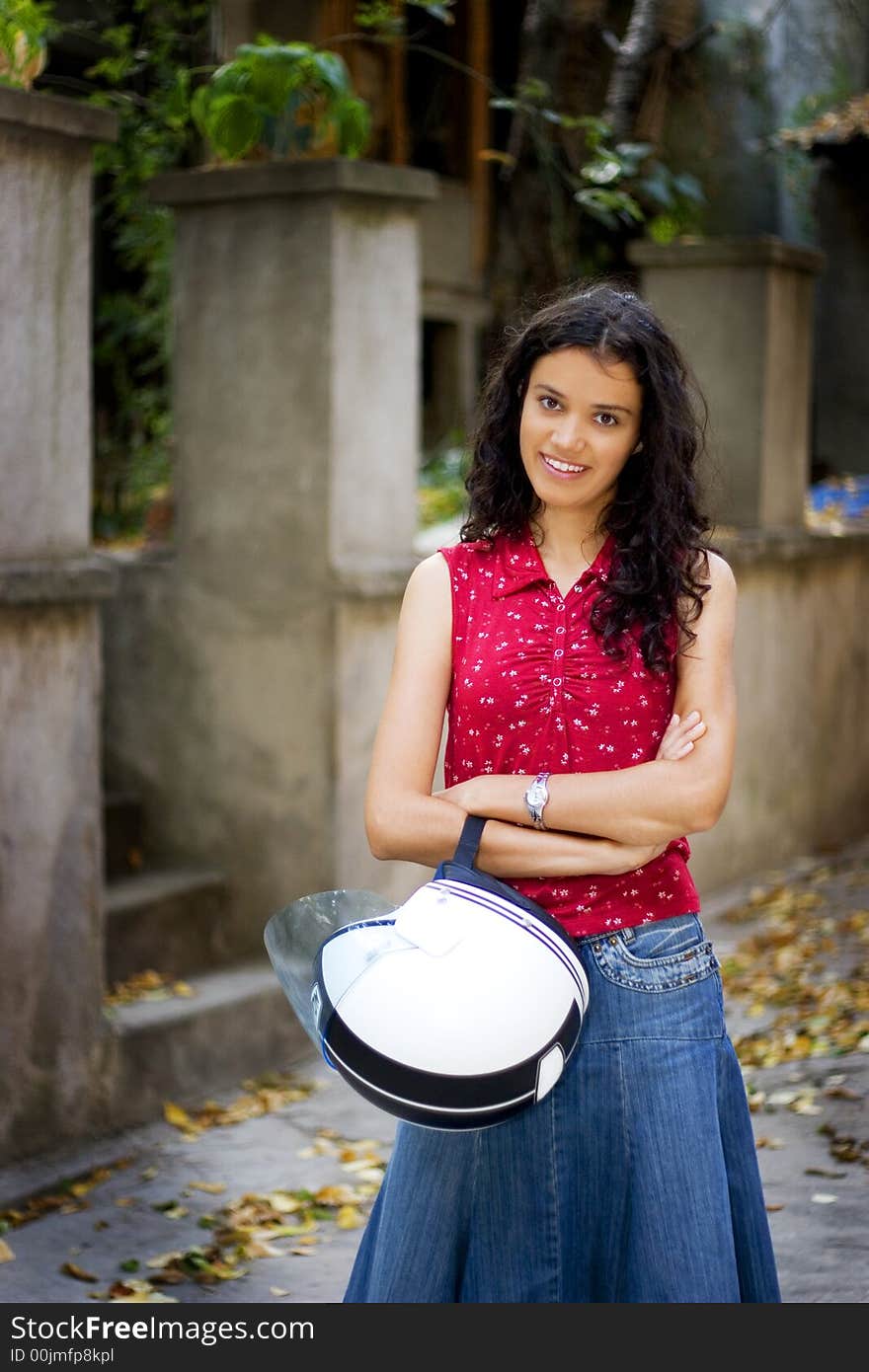 Beautiful young woman holding helmet. Beautiful young woman holding helmet