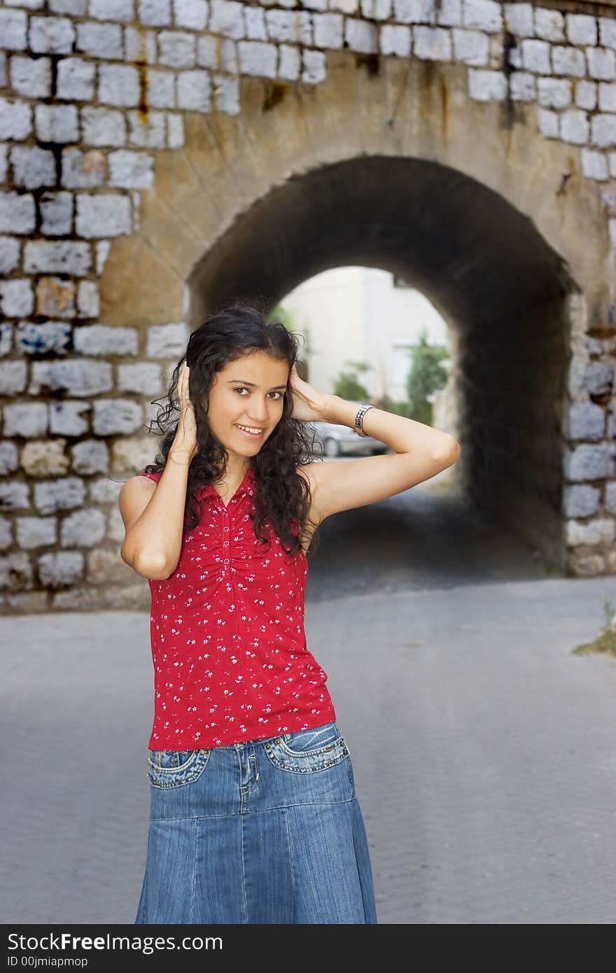 Beautiful smiling young woman in red on street. Beautiful smiling young woman in red on street