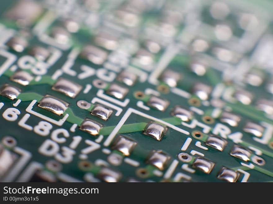 Motherboard's green electronic circuit - macro with shallow depth of field. Motherboard's green electronic circuit - macro with shallow depth of field