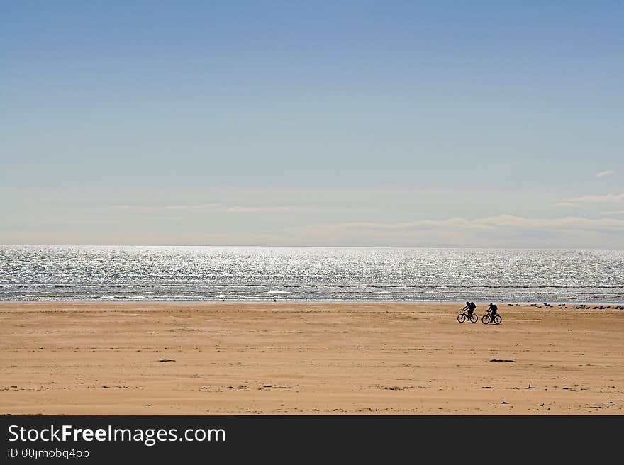 Two Cyclists On Beach