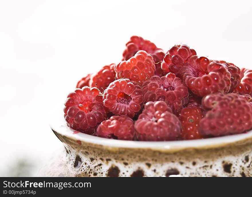 Raspberries in ceramic pot