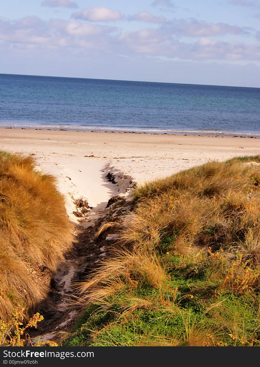 Entrance through the grass to the beach. Entrance through the grass to the beach.