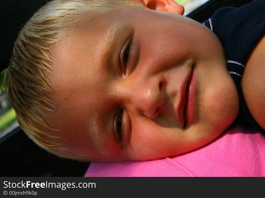 Young boy relaxing on the park bench. Young boy relaxing on the park bench