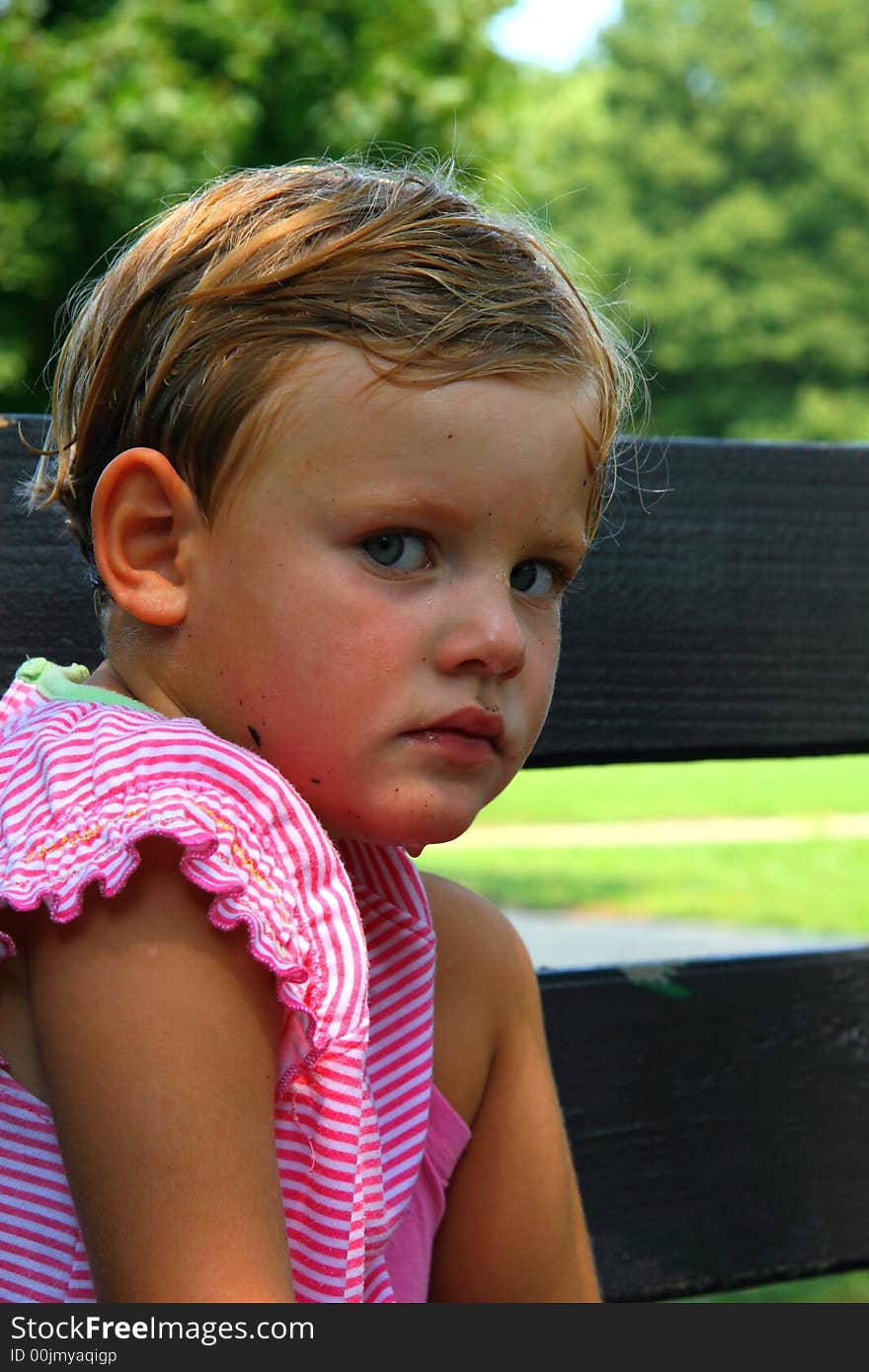 Portrait of tired girl sitting on the bench in the park. Portrait of tired girl sitting on the bench in the park