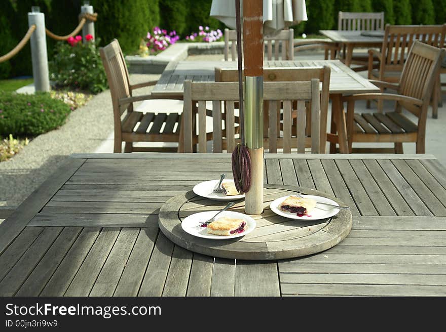 Pie being served on a wooden patio table. Pie being served on a wooden patio table