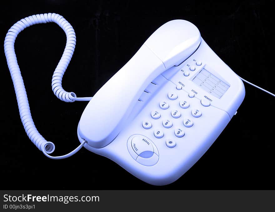 A telephone, blue tint against black