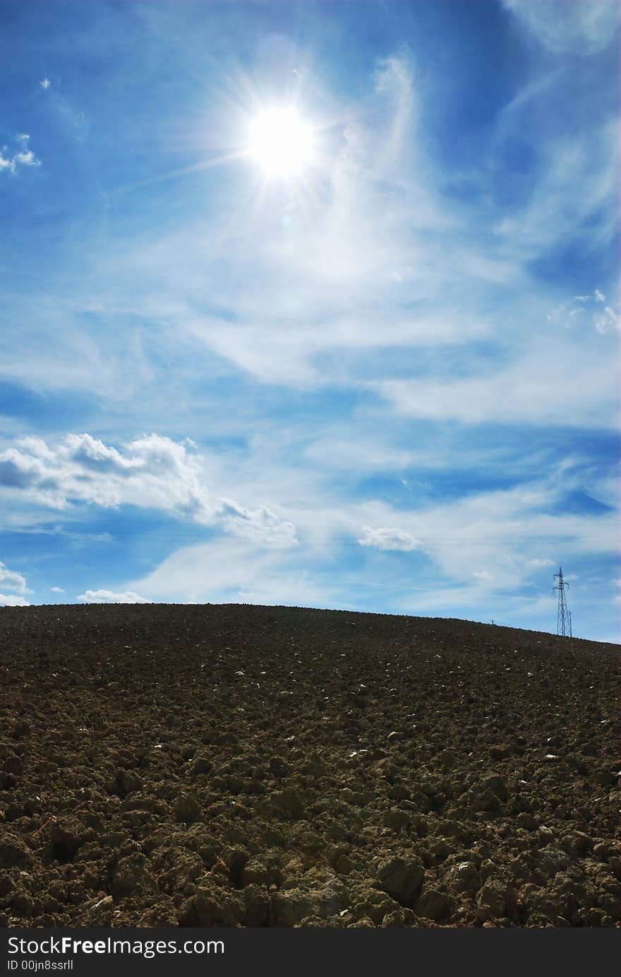 Sunny sky background over plowed land. Sunny sky background over plowed land