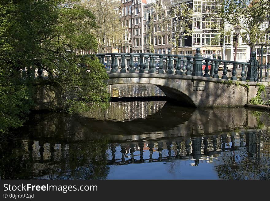 Reflection of bridge in a Amsterdam canal. Reflection of bridge in a Amsterdam canal