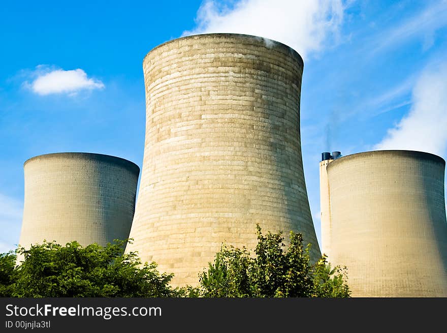 Three power station cooling towers and chimney