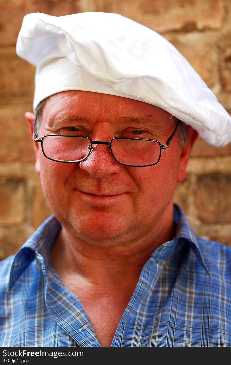 Portrait of a cook on the brick wall