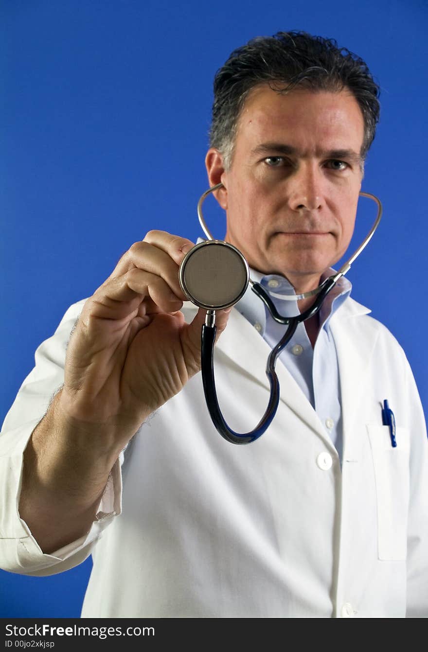 A picture of a man with a stethoscope, with the end of the stethoscope being the focus. A picture of a man with a stethoscope, with the end of the stethoscope being the focus.