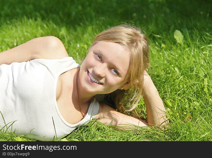 Smiling Girl Lying On Grass