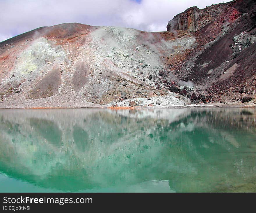 Colored mountain reflected in water