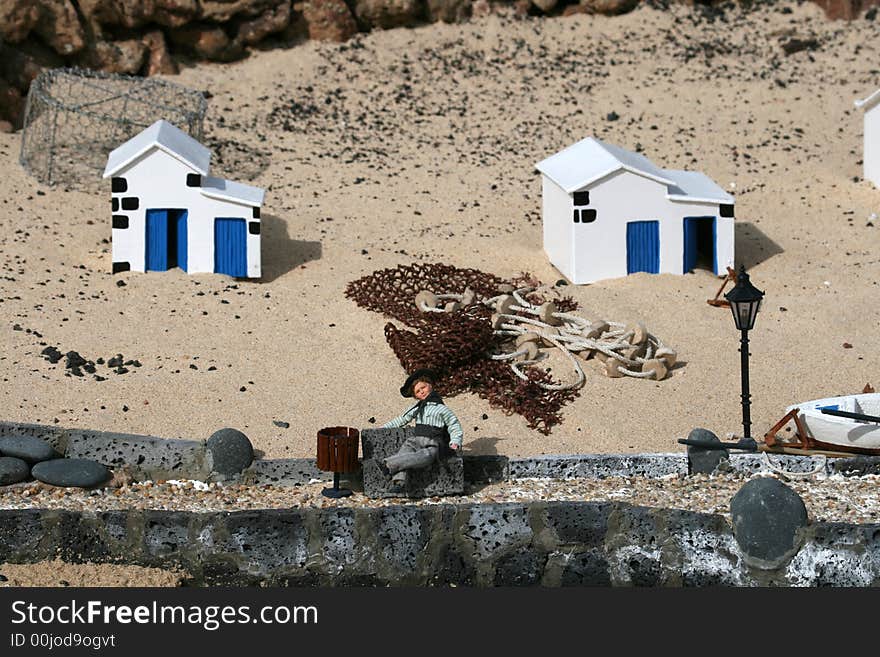 Miniature fisherman village scene with wooden boats