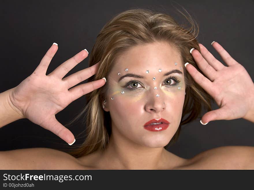 Closeup of a pretty young woman holding her outstretched hands near her face. Closeup of a pretty young woman holding her outstretched hands near her face