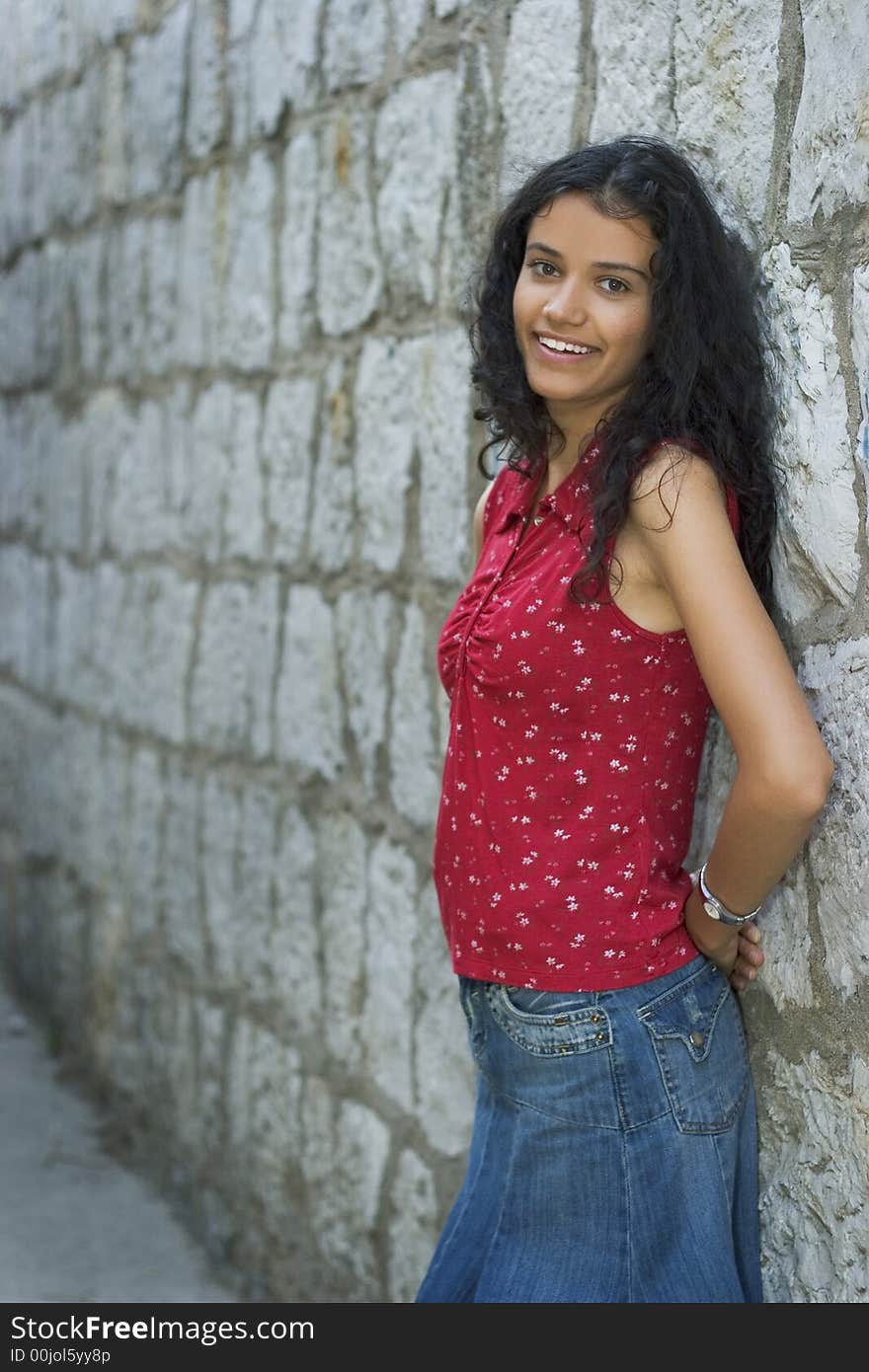 Beautiful smiling young woman in red on street. Beautiful smiling young woman in red on street