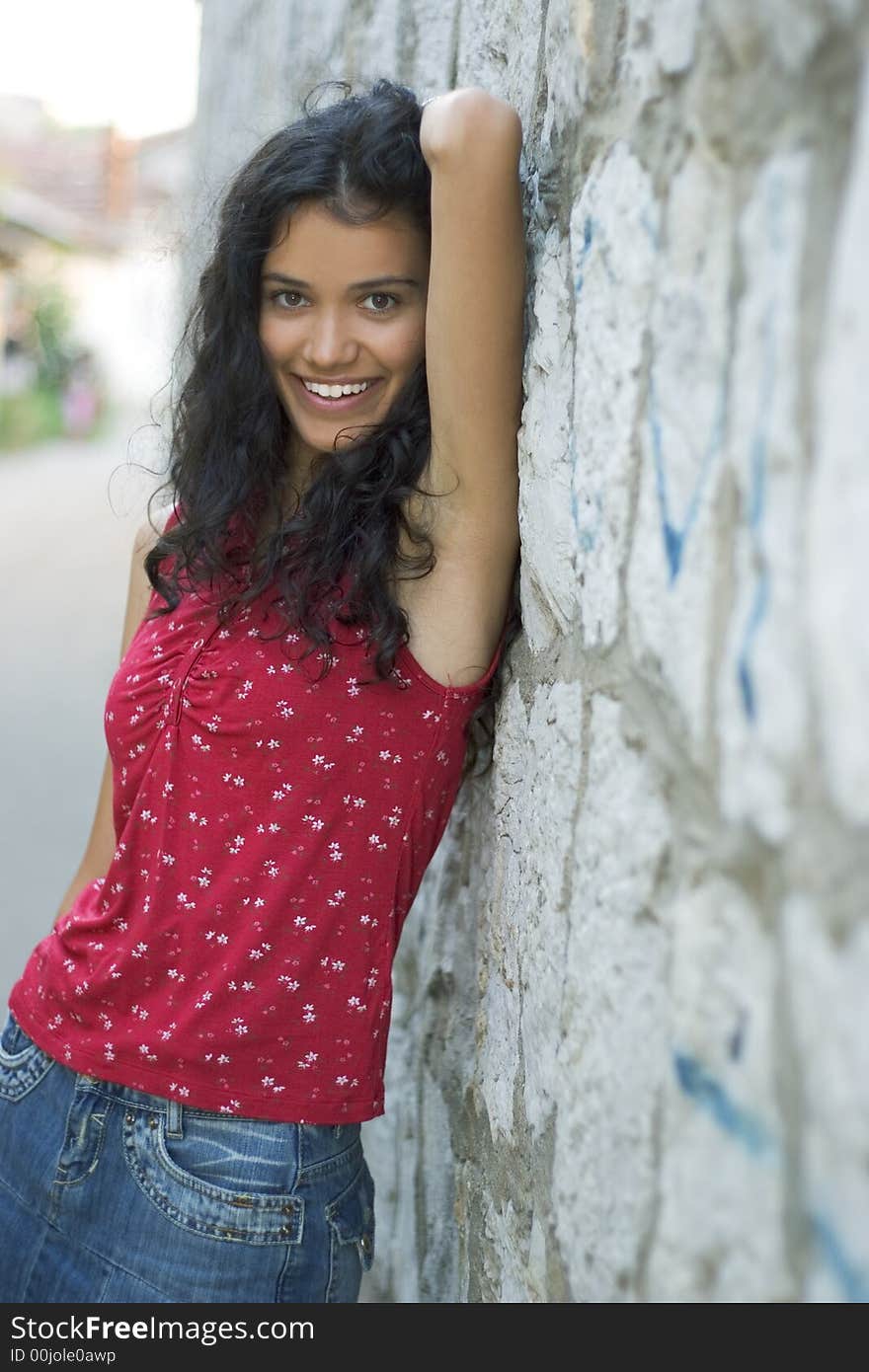 Beautiful smiling young woman in red on street. Beautiful smiling young woman in red on street