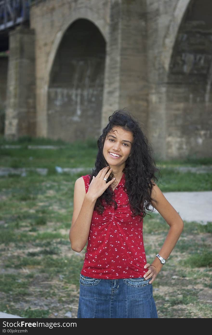 Beautiful smiling young woman in red on street. Beautiful smiling young woman in red on street