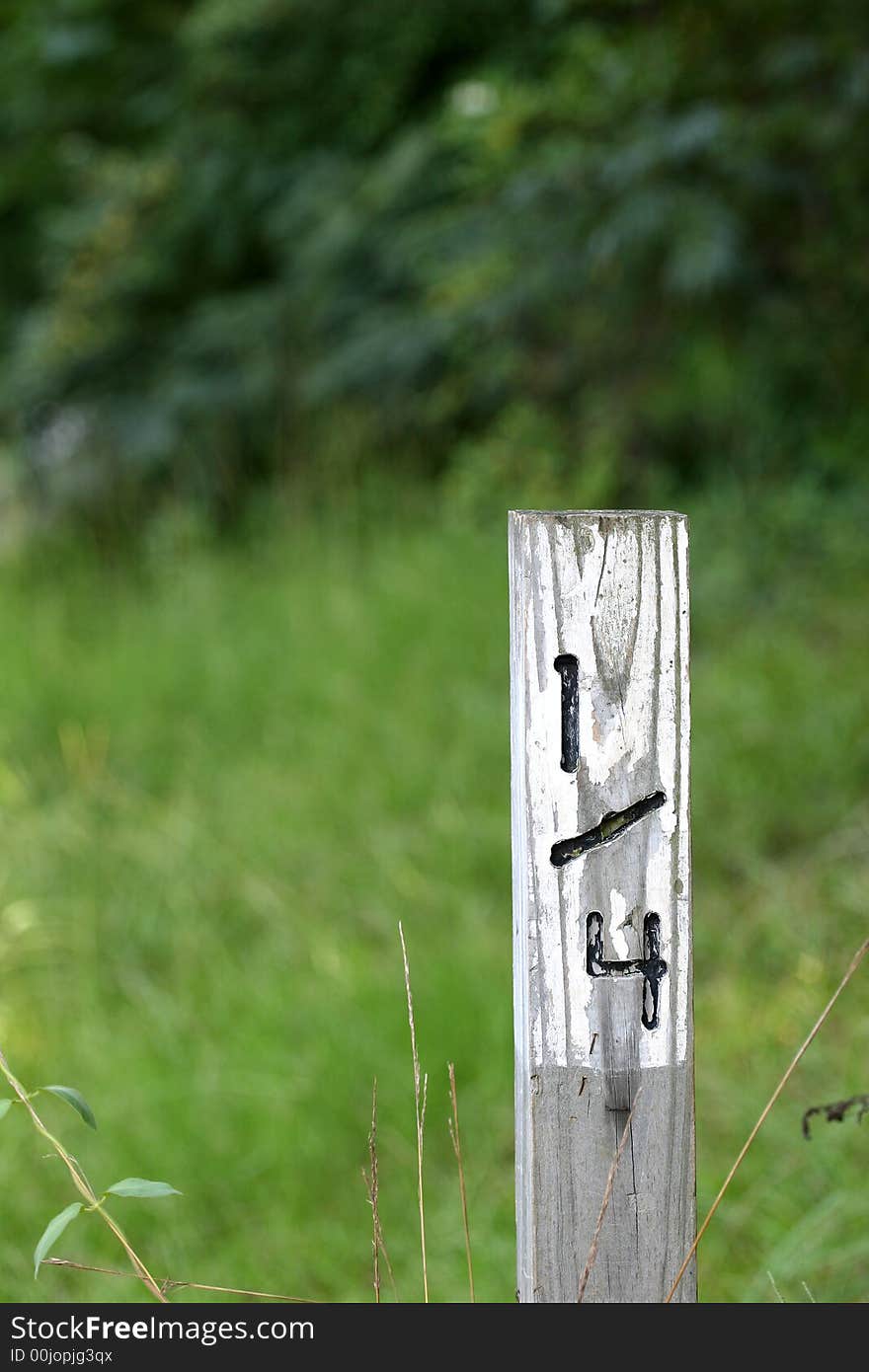 An old weathered mile marker at one quarter mile