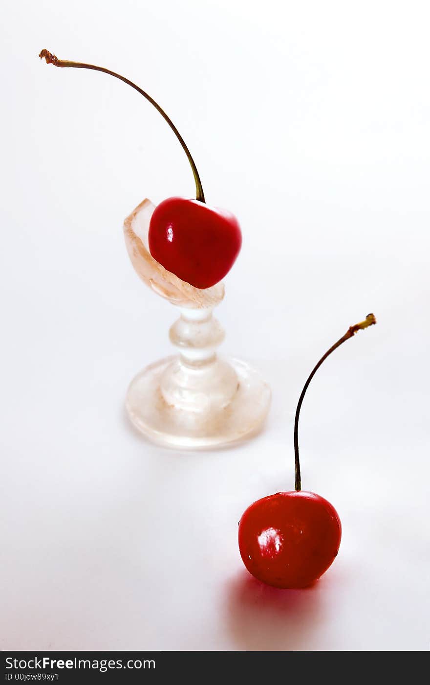 Two cherries on a white background