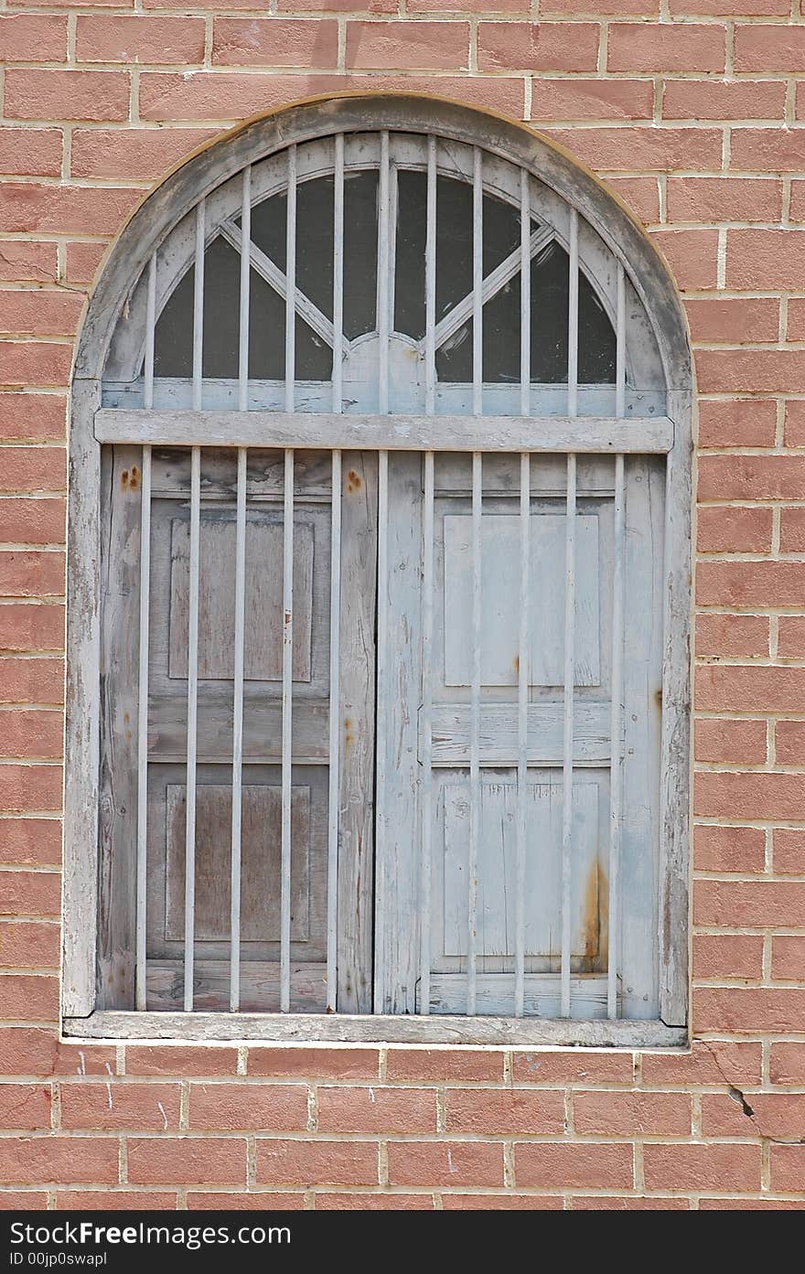 Home Window with Red Bricks and Grill