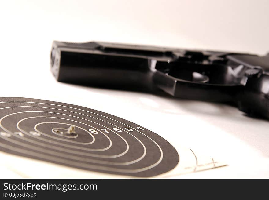 Photo of black gun on the white background