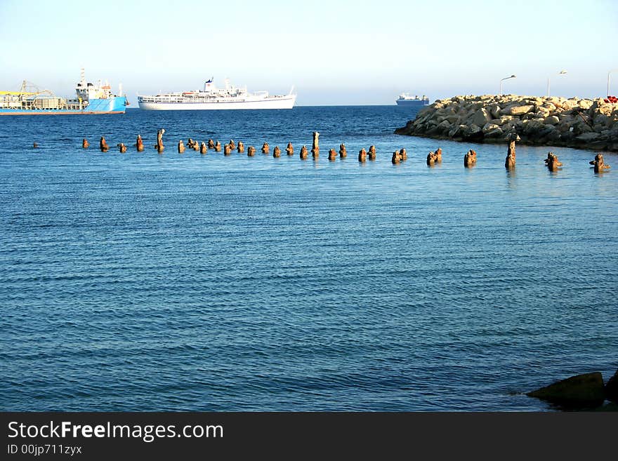 Old broken pier goes to the sea.